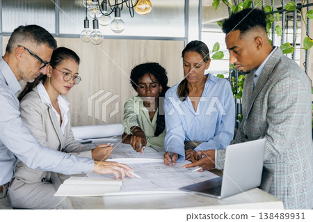 Black structural engineer explaining technical details to white and asian 138489931