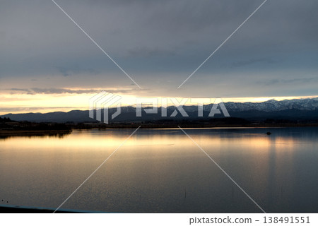 The snow-covered Hakusan mountain range and Shibayama Lagoon bathed in the morning light. The snow-covered Hakusan mountain range and Shibayama Lagoon bathed in the morning light. 138491551