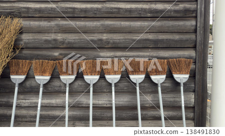 A broom leaning against a wall A broom leaning against a wall 138491830