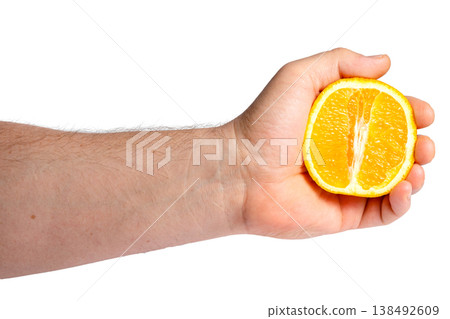 Male Hand Holding Half of Ripe Orange Male Hand Holding Half of Ripe Orange 138492609