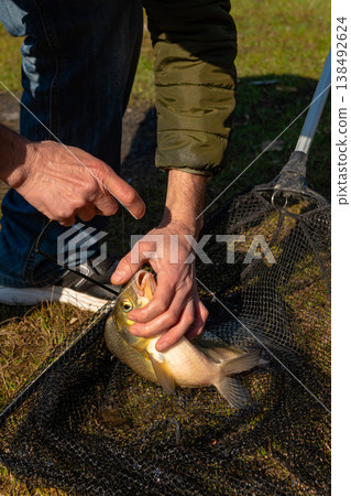 Proud Fisherman Showcasing Large Common Bream Proud Fisherman Showcasing Large Common Bream 138492624