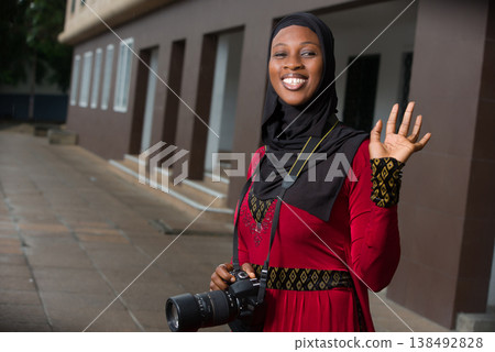 portrait of young muslim woman with camera, happy. portrait of young muslim woman with camera, happy. 138492828