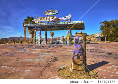 Abandoned Lake Dolores Water Park Entrance with Graffiti Palm Trees and Desert Landscape Abandoned Lake Dolores Water Park Entrance with Graffiti Palm Trees and Desert Landscape 138493372