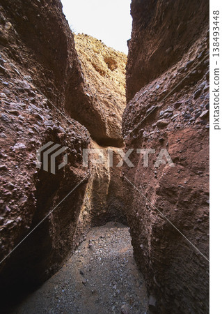Slot Canyon Walls and Sunlit Passageway in Desert 138493448