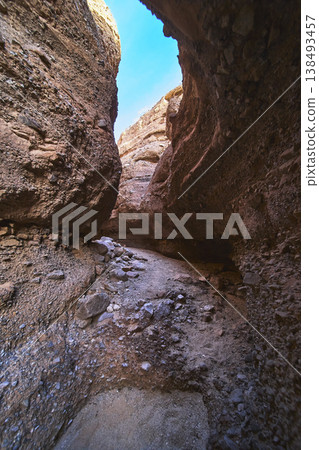 Slot Canyon Passage With Rugged Rock Walls And Blue Sky View Slot Canyon Passage With Rugged Rock Walls And Blue Sky View 138493457