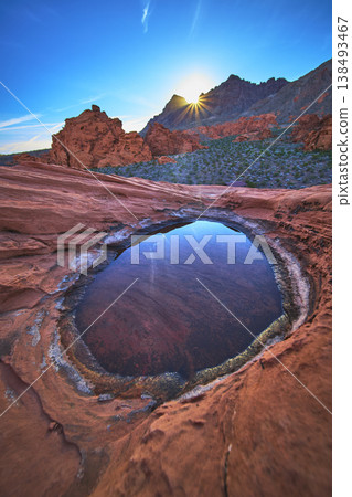 Redstone Dune Sunrise With Desert Tinaja Water Basin and Sunburst in Nevada Redstone Dune Sunrise With Desert Tinaja Water Basin and Sunburst in Nevada 138493467