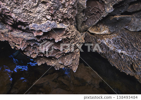 Lava Tube Rock Formations and Blue Light in Mojave Cave Interior 138493484