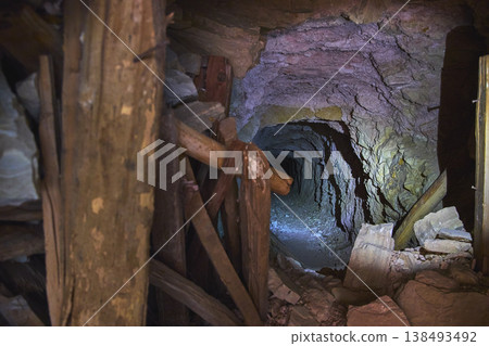 Abandoned Mine Tunnel with Wooden Supports and Rocky Debris in Nevada Abandoned Mine Tunnel with Wooden Supports and Rocky Debris in Nevada 138493492