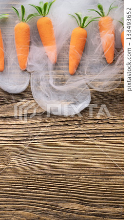 Creative carrots with smoke on rustic wooden background Creative carrots with smoke on rustic wooden background 138493652