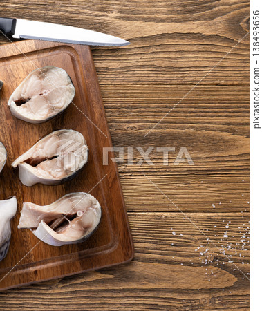 Raw mackerel fish steaks on wooden board Raw mackerel fish steaks on wooden board 138493656