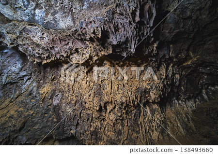 Lava Tube Ceiling Texture and Volcanic Rock Formation with Dramatic Natural Lighting Lava Tube Ceiling Texture and Volcanic Rock Formation with Dramatic Natural Lighting 138493660
