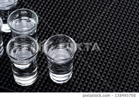 Vodka shot glasses on bar mat Vodka shot glasses on bar mat 138493708