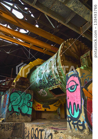 Graffiti Covered Abandoned Mining Mill Interior with Rusted Machinery and Broken Roof Graffiti Covered Abandoned Mining Mill Interior with Rusted Machinery and Broken Roof 138493766