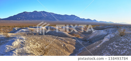 Panorama of Tule Springs Fossil Bed Badlands and Distant Mountain Range at Golden Hour Panorama of Tule Springs Fossil Bed Badlands and Distant Mountain Range at Golden Hour 138493784