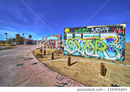 Abandoned Water Park Graffiti Urban Decay and Palm Trees in California Desert 138493804