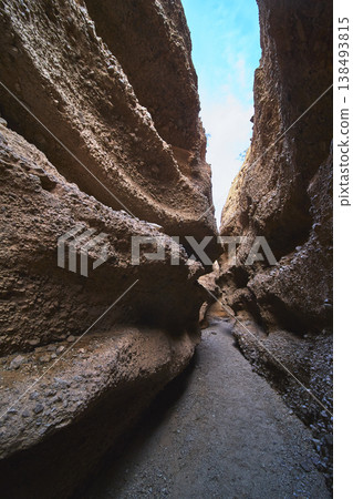 Slot Canyon Curved Sandstone Walls and Blue Sky Perspective Slot Canyon Curved Sandstone Walls and Blue Sky Perspective 138493815