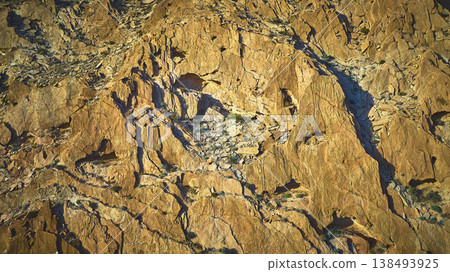 Aerial Desert Rock Face Texture and Sunlit Cliffs in Nevada Aerial Desert Rock Face Texture and Sunlit Cliffs in Nevada 138493925
