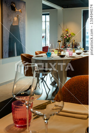 Chic table setting for romance. Refined table arrangement with delicate glassware and romantic ambiance Chic table setting for romance. Refined table arrangement with delicate glassware and romantic ambiance 138494074