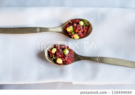 Closeup of vibrant dish details. Sharp studio shot showcasing garnishes and crispness of ingredients Closeup of vibrant dish details. Sharp studio shot showcasing garnishes and crispness of ingredients 138494094
