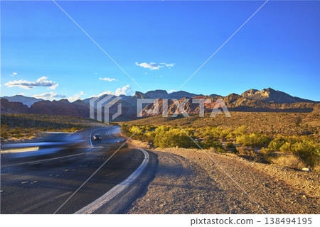 Red Rock Canyon Scenic Road With Cars at Golden Hour and Desert Mountains Red Rock Canyon Scenic Road With Cars at Golden Hour and Desert Mountains 138494195