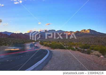 Red Rock Canyon Scenic Road with Blurred Cars and Dramatic Desert Mountains Nevada Red Rock Canyon Scenic Road with Blurred Cars and Dramatic Desert Mountains Nevada 138494214