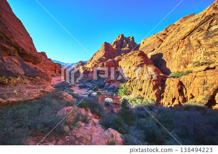 Red Rock Canyon Vibrant Sandstone Formations with Desert Vegetation and Blue Sky Red Rock Canyon Vibrant Sandstone Formations with Desert Vegetation and Blue Sky 138494223