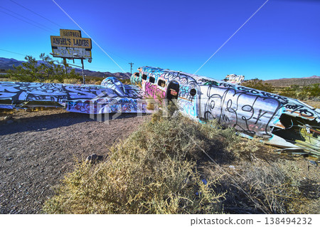 Graffiti Covered Abandoned Airplane and Brothel Sign in Nevada Desert Near Beatty Graffiti Covered Abandoned Airplane and Brothel Sign in Nevada Desert Near Beatty 138494232