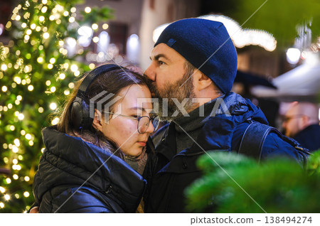 Cheerful Christmas Girl with Her Father and Festive Lights Cheerful Christmas Girl with Her Father and Festive Lights 138494274