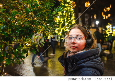 Cheerful Christmas Girl with Festive Lights Cheerful Christmas Girl with Festive Lights 138494331