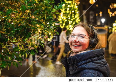 Cheerful Christmas Girl with Festive Lights Cheerful Christmas Girl with Festive Lights 138494334
