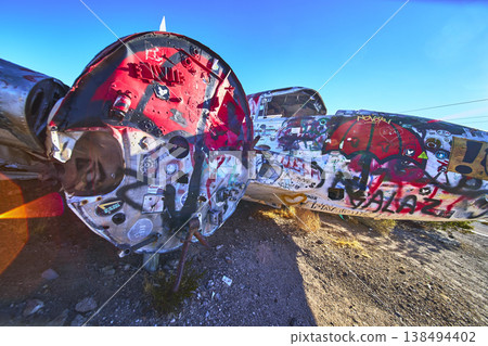Graffiti Covered Abandoned Airplane Wreck in Desert Sunlight Near Beatty Nevada Graffiti Covered Abandoned Airplane Wreck in Desert Sunlight Near Beatty Nevada 138494402