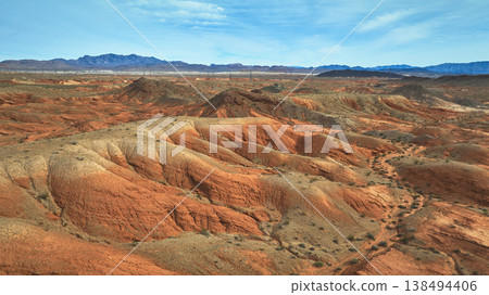 Aerial Red Sandstone Hills and Desert Landscape with Distant Mountains Aerial Red Sandstone Hills and Desert Landscape with Distant Mountains 138494406