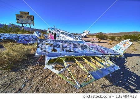 Graffiti Covered Airplane Wreck in Nevada Desert With Vintage Brothel Sign Graffiti Covered Airplane Wreck in Nevada Desert With Vintage Brothel Sign 138494418