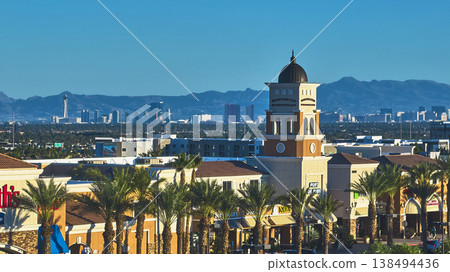 Aerial Las Vegas Shopping Center Palm Trees and Distant Strip Skyline at Golden Hour Aerial Las Vegas Shopping Center Palm Trees and Distant Strip Skyline at Golden Hour 138494436