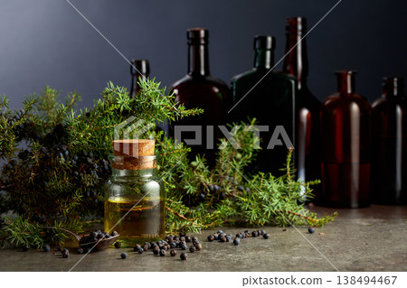 Juniper berry essential oil and branches with fresh berries. 138494467