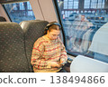 Smiling teenager girl with gallses and headphones in train 138494866
