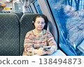 Smiling teenager girl with gallses and headphones in train 138494873
