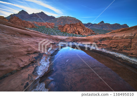 Redstone Dune Desert Tinaja with Water at Sunrise in Vibrant Nevada Landscape Redstone Dune Desert Tinaja with Water at Sunrise in Vibrant Nevada Landscape 138495010