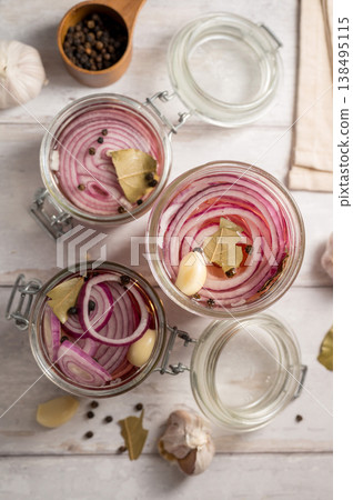 Homemade pickled red onions in jars, bright background Homemade pickled red onions in jars, bright background 138495115