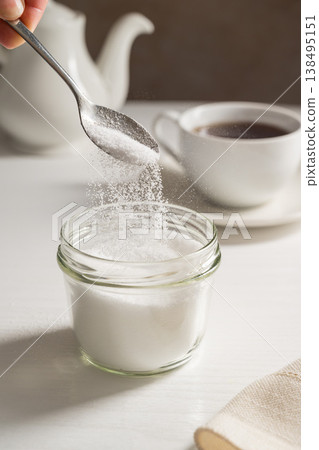 Pouring spoon of sweetener in a jar. Sugar alternative, food and nutrition 138495151