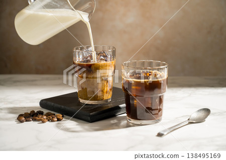 Glass with iced latte, refreshing energy coffee drinks Glass with iced latte, refreshing energy coffee drinks 138495169