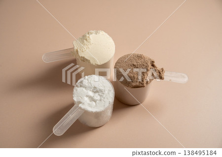 Collagen, creatin or protein powder in scoops. Food supplement, fitness sport, health and nutrition. Collagen, creatin or protein powder in scoops. Food supplement, fitness sport, health and nutrition. 138495184
