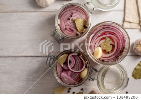 Cooking homemade pickled red onions in jars, bright background Cooking homemade pickled red onions in jars, bright background 138495200