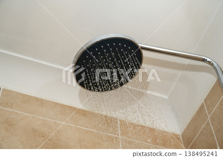 Chrome shower head with water droplets. Increasing water bills. Chrome shower head with water droplets. Increasing water bills. 138495241