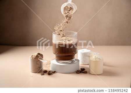 Chocolate protein powder pouring in a glass. Food supplement, fitness sport, health and nutrition. Chocolate protein powder pouring in a glass. Food supplement, fitness sport, health and nutrition. 138495242