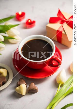 Valentine's day. Cup of coffee, heart chocolates, gift box and spring white tulip flower bouquet. Mother's day Valentine's day. Cup of coffee, heart chocolates, gift box and spring white tulip flower bouquet. Mother's day 138495300