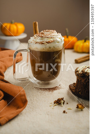 Pumpkin spice latte in glass mug with whipped cream and cinnamon, autumn hot drink 138495397