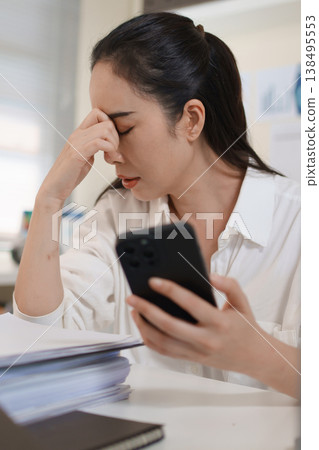Stressed businesswoman reacting to financial loss and investment risk after checking smartphone 138495553