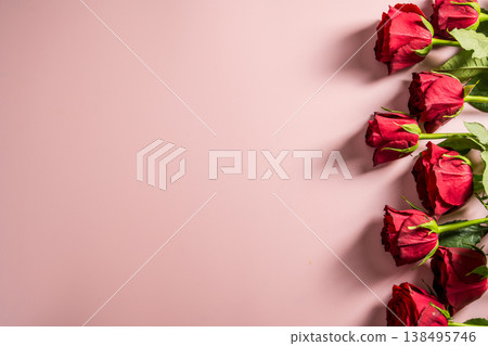 Valentine's Day background. Red roses flower bouquet over pink background. Abstract flat lay. Festive greeting card. Valentine's Day background. Red roses flower bouquet over pink background. Abstract flat lay. Festive greeting card. 138495746