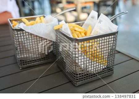 Egypt, Sharm el-Sheikh - September 30, 2025 French fries in newspaper and wire mesh. Editorial Egypt, Sharm el-Sheikh - September 30, 2025 French fries in newspaper and wire mesh. Editorial 138497831
